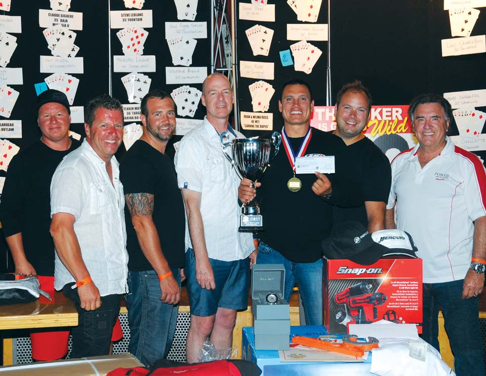 FIRST PLACE: Patrick Higgins and Team Go Fast. Bill Taylor (far right) and Richard Allard of Golden Anchor Marina (second from left) presents owner Patrick Higgins (center) with the first place trophy.