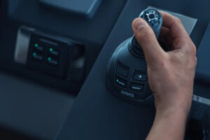 a hand holding a black video game controller
